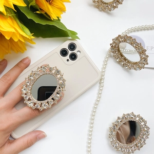 Detail view of foldable phone grip with sparkling rhinestones and makeup mirror