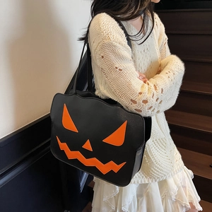 Chic black Halloween pumpkin tote bag with orange face embroidery and long shoulder straps