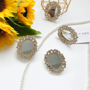 Close-up of sparkling rhinestone mirror phone grips with vintage gold trim and sunflowers