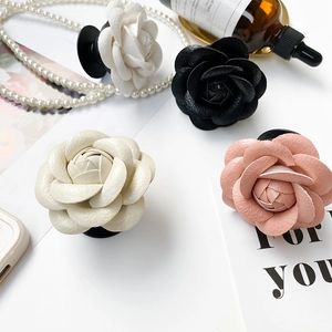 Detail of camellia flower phone sockets with lychee leather texture and folding base