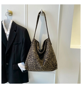 Detail of hobo leopard print tote bag in soft suede fabric with long shoulder strap