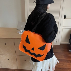 Fashionable pumpkin shoulder bag for Halloween with orange leather and black face pattern