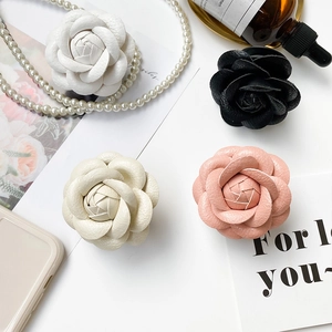 Detail of camellia flower phone grips in four colors with premium lychee leather texture