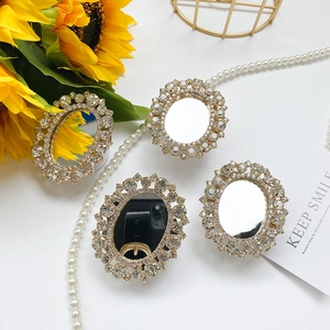Detail of elegant gold oval phone holder with double-row sparkling rhinestones and mirror