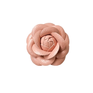 Detailed view of pink camellia phone stand with 3D leather texture and multilayered petals