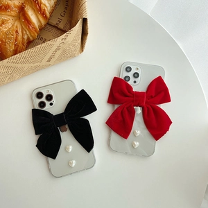 Clear iPhone case with a large velvet bow and heart pearl accents in red and black