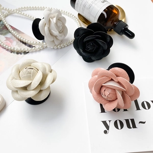 3D camellia flower phone socket grips in cream, white, pink and black leather textures