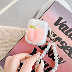 Detail of clear AirPods case with 3D pink peach charm and elegant pearl lanyard
