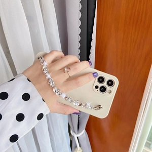 Detail of cream iPhone case with sparkling rhinestone chain strap and precise lens cutouts
