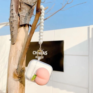 Close-up of clear AirPods case featuring a 3D pink peach charm and elegant pearl lanyard