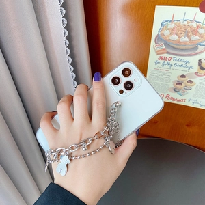 Transparent iPhone case with silver layered chain and cute bear charms in hand