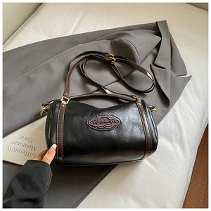 Detail shot of the vintage black oil wax leather boston bag with logo and strap