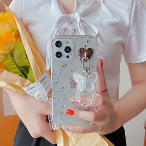 Detail of silver foil iPhone case with butterfly charm and beaded wrist strap handle