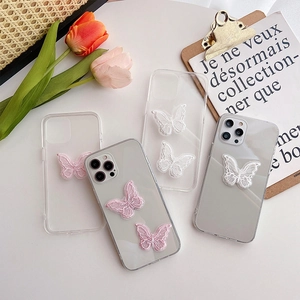 Detail of transparent iPhone case with pink and white embroidered lace butterflies