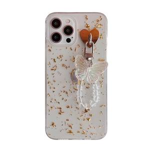 Detail of iPhone case featuring gold foil flakes and iridescent butterfly charm bracelet