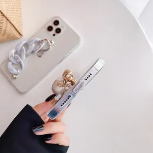 Detail of transparent phone case with detachable marble texture chain and gold buckle