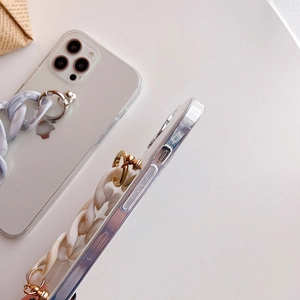 Detail of transparent iPhone case featuring a stylish marble link bracelet and gold loops