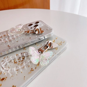 Detail of clear iPhone case with gold foil, beaded chain and iridescent butterfly charm