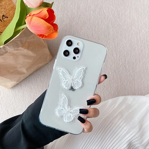 Detailed view of clear iPhone case with 3D white lace butterfly floral design