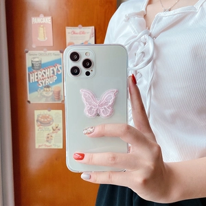 Detail of pink lace butterfly phone socket on clear case for iPhone 16 Pro Max