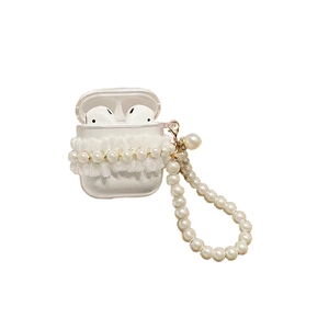 Detail of clear AirPods case with white lace edges and a chunky pearl bead wrist strap