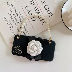 iPhone case with 3D white camellia flower, black bow and elegant pearl hand strap