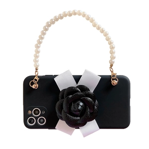 Elegant iPhone case featuring a black camellia, ribbon bow, and white pearl handle strap