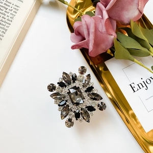Detailed close-up of retro luxury brooch with grey rhinestones and marquise cut stones