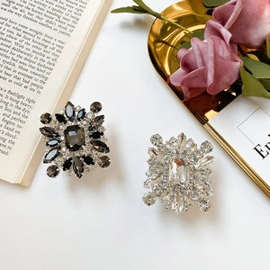 Close-up of sparkling rhinestone phone socket with luxury crystal flower design on white background