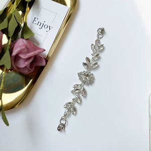 Detailed macro view of an elegant silver leaf crystal accessory with sparkling rhinestones