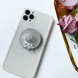 Detail view of a silver woven hat phone socket with bow on a minimalist case