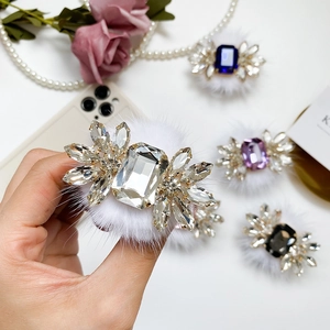 Detailed view of crystal rhinestone hair accessories with luxury plush fur in various colors