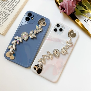 Luxe phone cases with rhinestone leaf chain and heart hooks in blue and pink marble