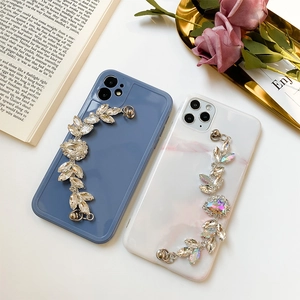 Luxe rhinestone chain phone cases in matte blue and marble pink for iPhone models