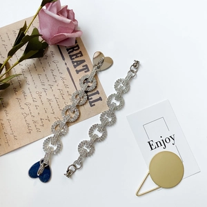 Elegant rhinestone bracelet with silver-tone interlocking circles and heart pendant detail