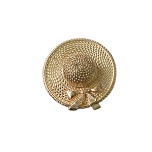 Close-up of golden straw hat phone grip featuring intricate woven texture and a bow