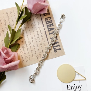 Detailed view of silver rhinestone heart bracelet for phone cases with shiny crystal gems