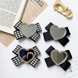 Detailed set of four bow hair clips with heart mirrors and sparkling rhinestones