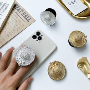 Macro detail of electroplated straw hat phone sockets with elegant bow and woven texture