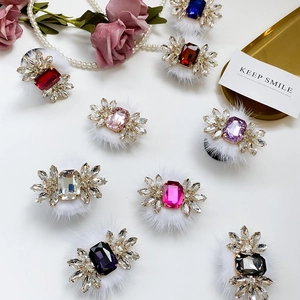 Detailed view of luxury rhinestone hair ties with colorful gemstones and faux fur accents