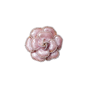 Pink camellia desktop phone stand with pearl trim and elegant marble texture finish