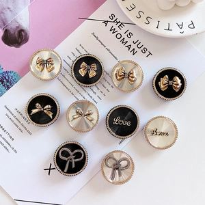 Close-up of vintage metallic bow and Love letter phone grip holders on a magazine