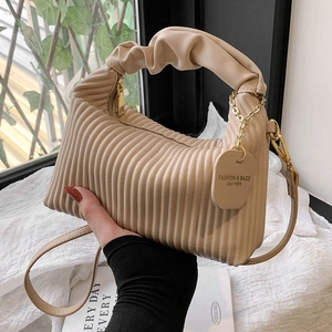 Chic beige pleated cloud hobo bag with vertical stripes and elegant gold chain detail