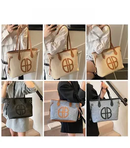 Detailed views of large canvas tote bag with leather trim worn as an underarm shoulder bag