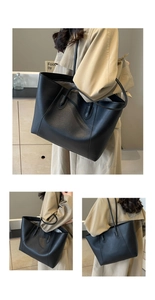 Close-up of matte black leather tote bag with vertical stitching and slim straps