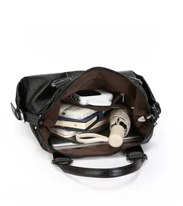 Detail of large capacity black tote bag interior showing compartments and storage items