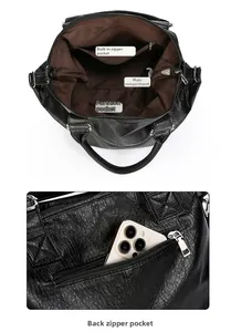 Detail of black tote bag interior pockets and rear zipper compartment with brown lining