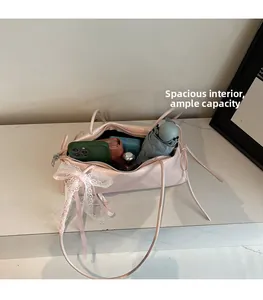 Interior view showing large capacity of the pink balletcore bag with lace bow detail