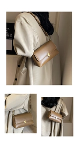 Detail of a vintage brown leather square bag featuring a gold buckle and woven strap