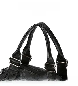 Detail of reinforced handles and silver metal buckles on a textured black tote bag